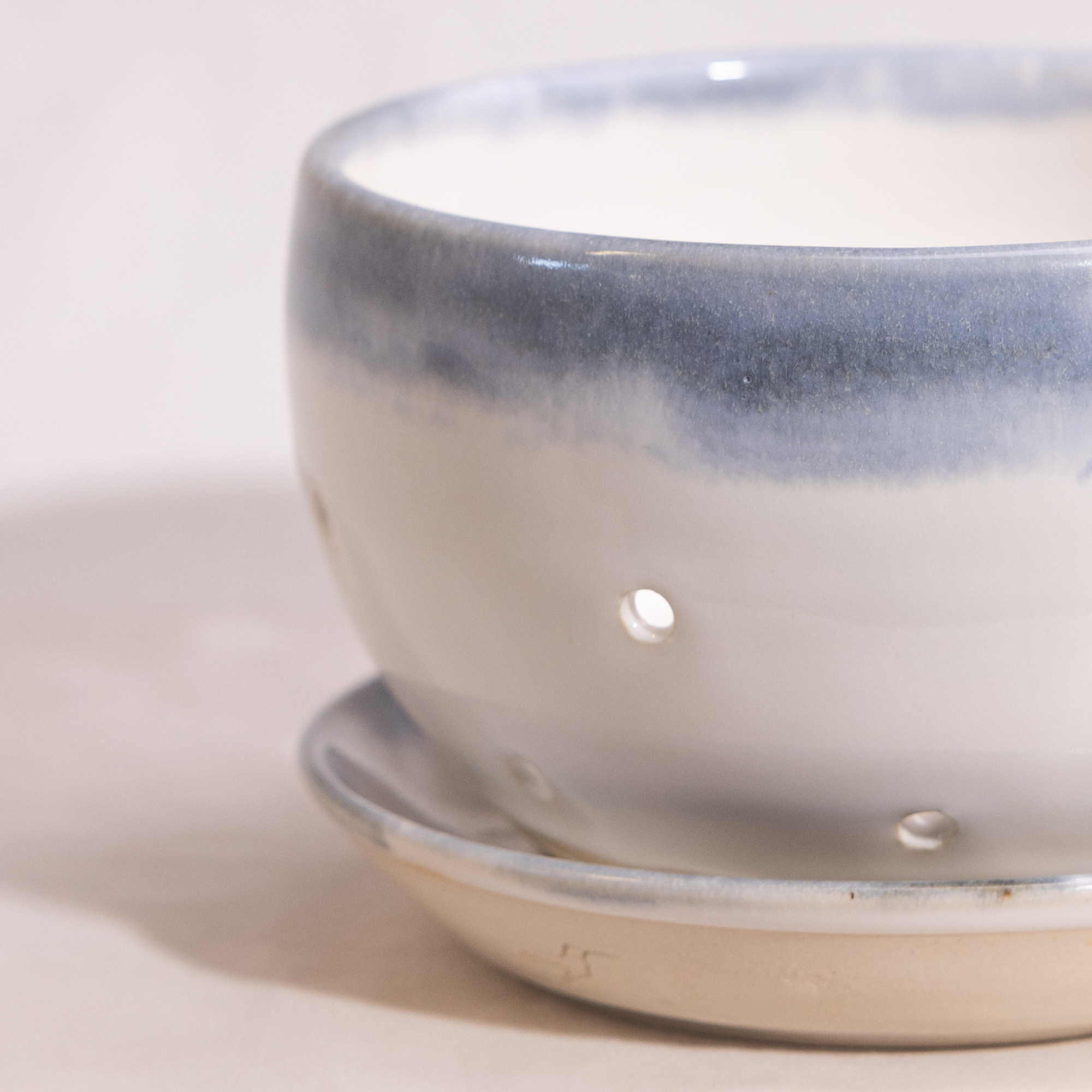 Stoneware berry bowl with separate drain plate.